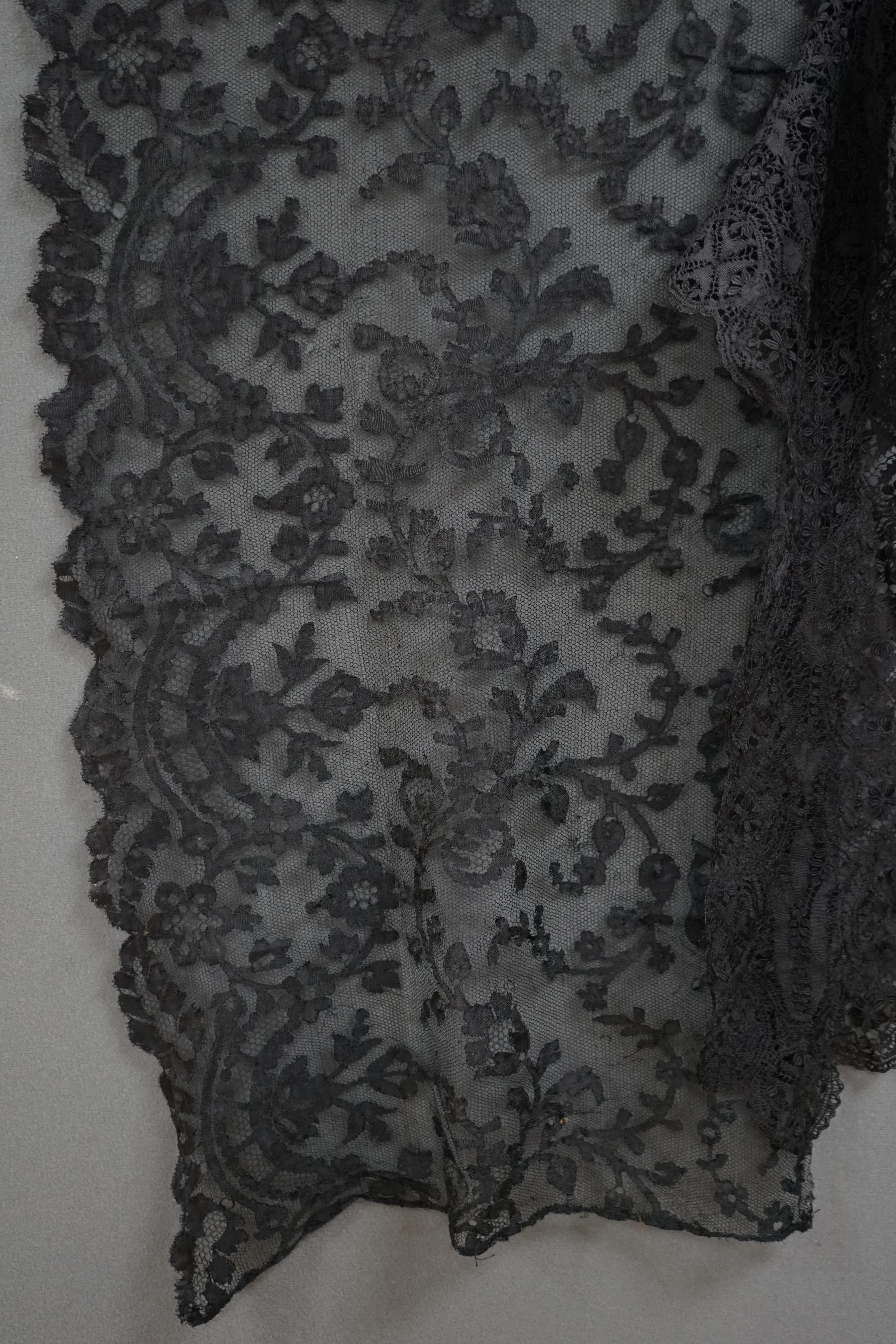 A collection of late 19th century black bobbin laces. A silk Maltese bobbin lace ‘fall cap’, a long black silk stole, possibly Spanish, a scalloped edge bobbin lace bonnet veil possibly French and a large black machine m